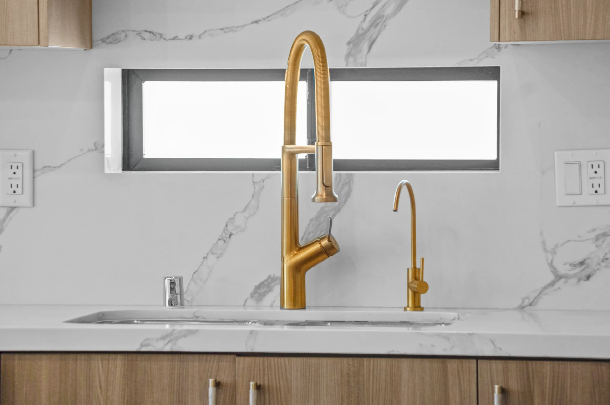 Luxury kitchen with modern white cabinets and stainless steel appliances – professional real estate photography Los Angeles.